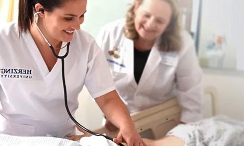 Nurse Instructor Teaching Student to Use Stethoscope