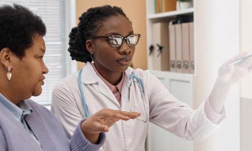 Primary care nurse practitioner with DNP speaking with patient about treatment options 