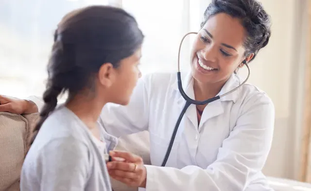 Primary Care Pediatric Nurse Practitioner Taking Heart Rate of Child Patient